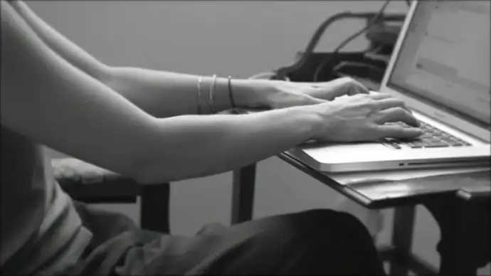 black white clip of woman typing on laptop