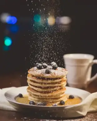 closeup of flour falling on cake
