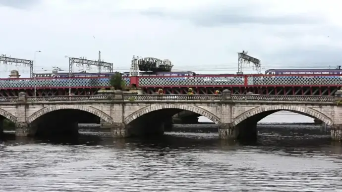 busy traffic on ancient brick bridge