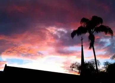 church steeple silhouette on sunset clouds