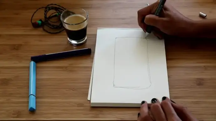 clip of woman drafting with pencil on paper