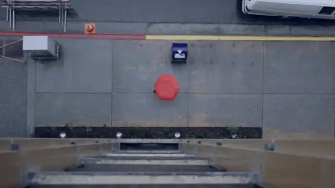 clip of young woman walking with red umbrella