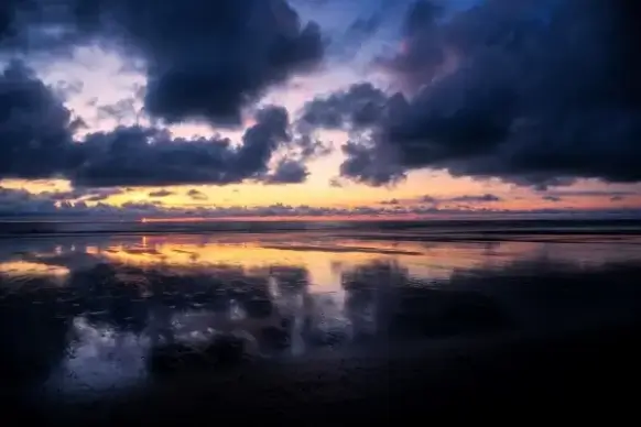 big cloudscape above calm lake