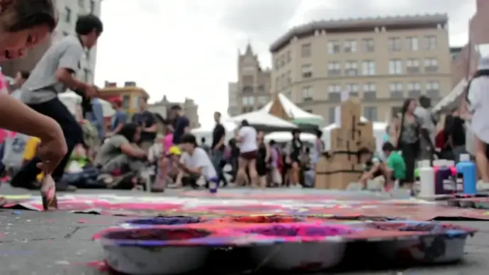 crowded people enjoying painting in street festival