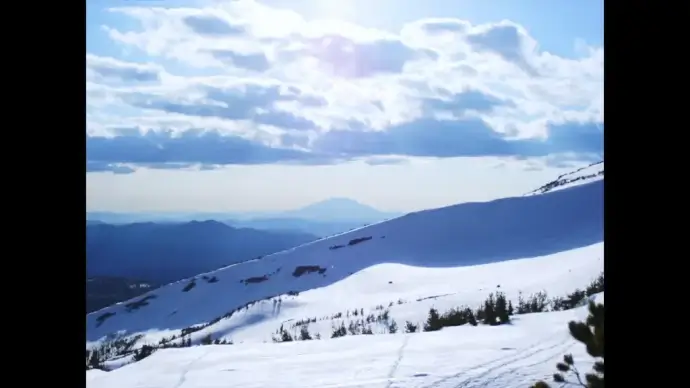 fast clip of cloudscape flying above snowy mountain