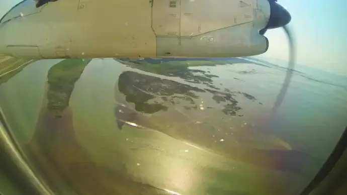 fast clip of scenery shot from classical airplane