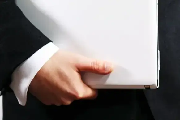 hand holding laptop