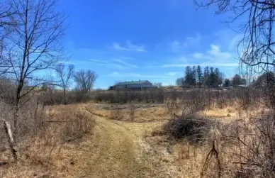 house in the distance on the 400 trail in wisconsin