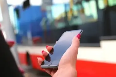 iphone 6 in hand at the bus station