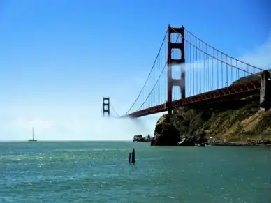 looking up at golden gate bridge in fog