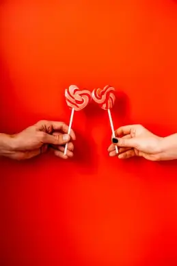 love backdrop hands holding heart shape candies