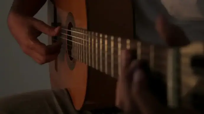 man playing acoustic guitar