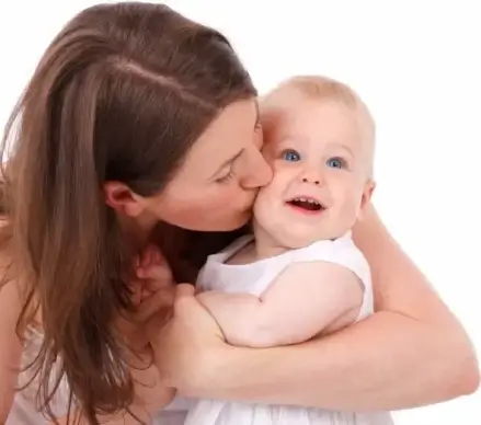 mother kissing baby