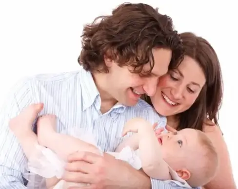 parents holding baby
