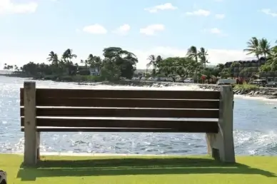 park bench on beach facing ocean