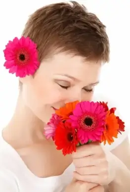 smelling bouquet of flowers
