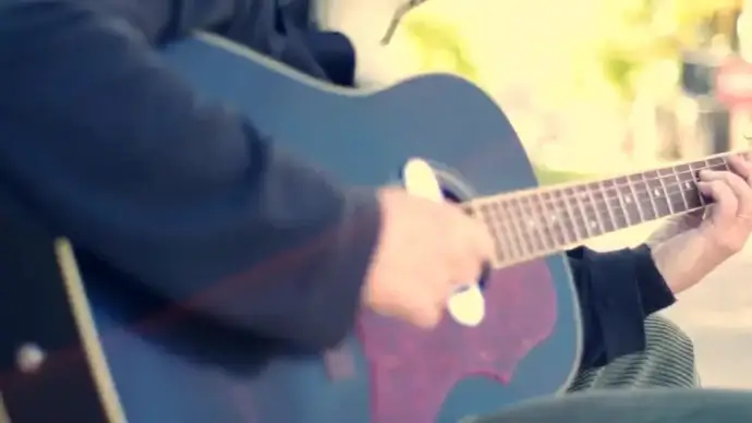 street performer earning with guitar