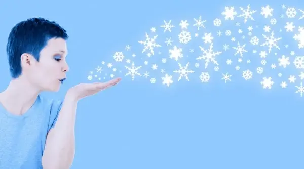 winter girl blowing snow