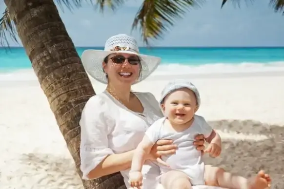 woman and baby on the beach