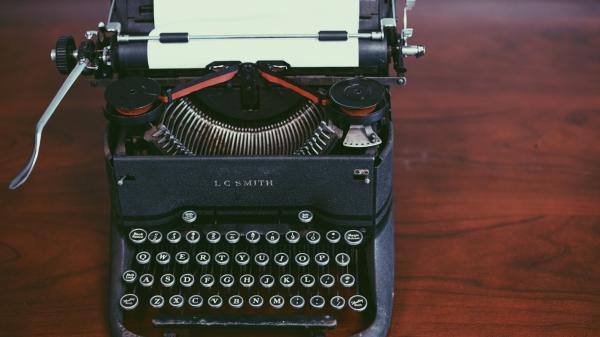 antique typewriter on wooden table