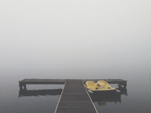 beach bench boardwalk boat empty fog horizon island