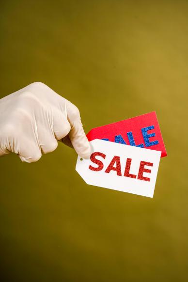 black friday sale poster hand holding tags closeup