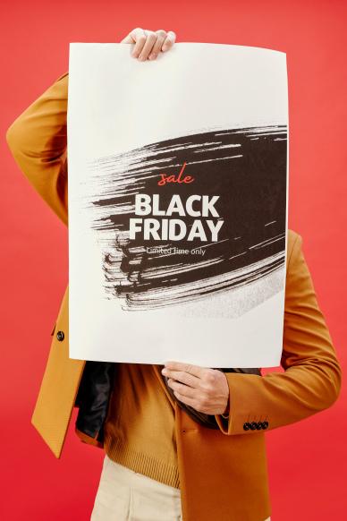 black friday sale poster mand holding grunge abstract paper