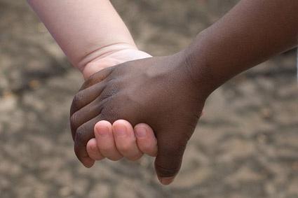 blacks and whites holding hands stock photo