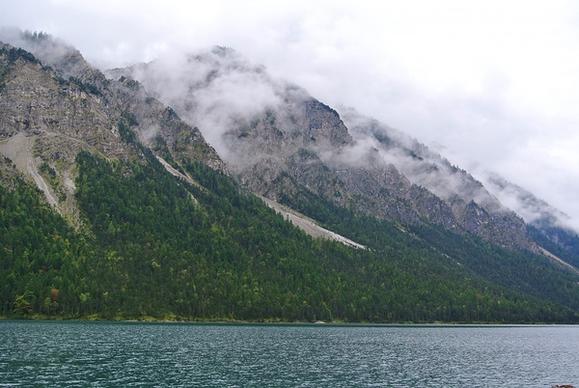 boat fjord fog forest hill island lake landscape
