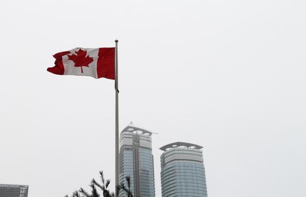 canadian flag pole on overcast sky