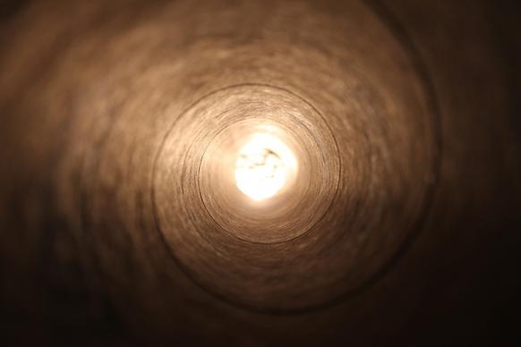 close up curve inside light spiral tube tunnel