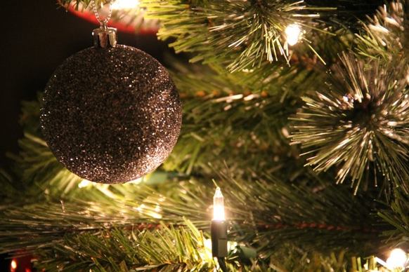 close up of christmas tree with silver ball ornament