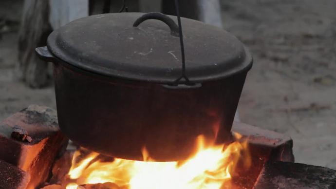 closeup of traditional pot on cooking fire