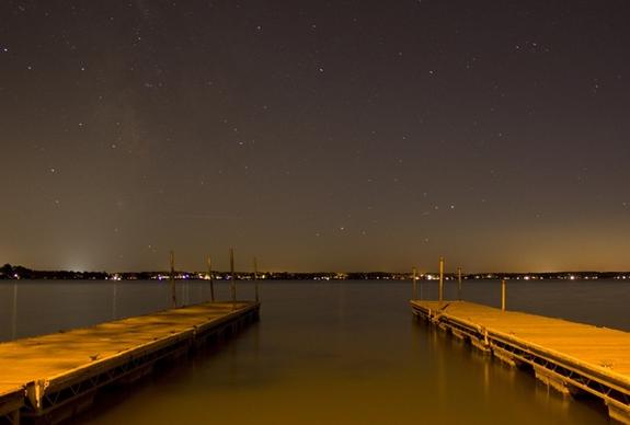 docks in darkness under the light at lake kegonsa state park wisconsin