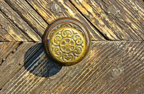 old wooden door with classical metallic knob