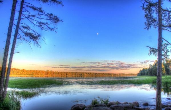dusk with moon in the sky at lake itasca state park minnesota