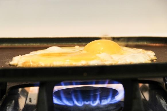 eggs cooking on frying pan over stove