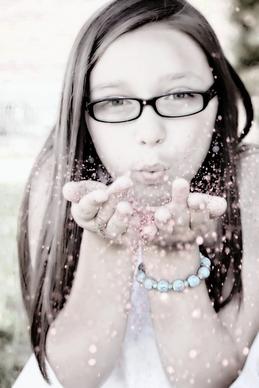 girl blowing glitter face portrait