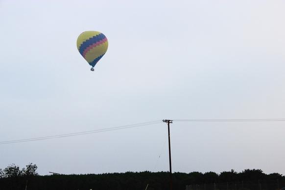hot air balloon trees in overcast sky
