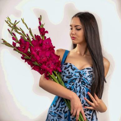 lifestyle picture woman holding gladiolus bouquet