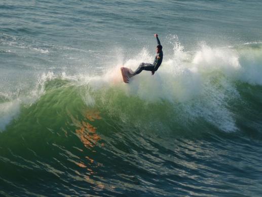 longboard surfer on the wave crest