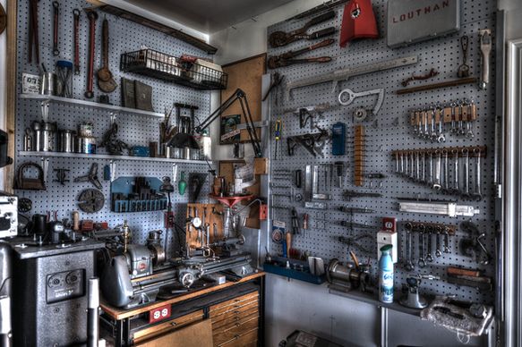 machine room wall with lathe tooling and metal chop saw