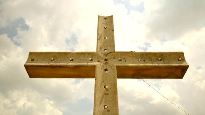 metallic christian cross under sky
