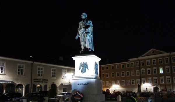 mozart statue in salzburg at night