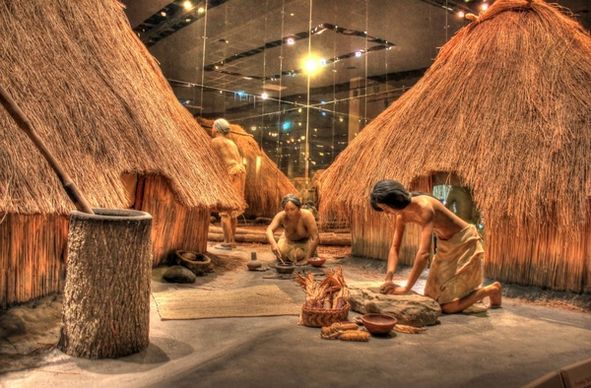 native americans working besides houses at cahokia mounds illinois