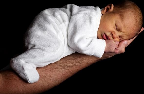 newborn baby on an arm