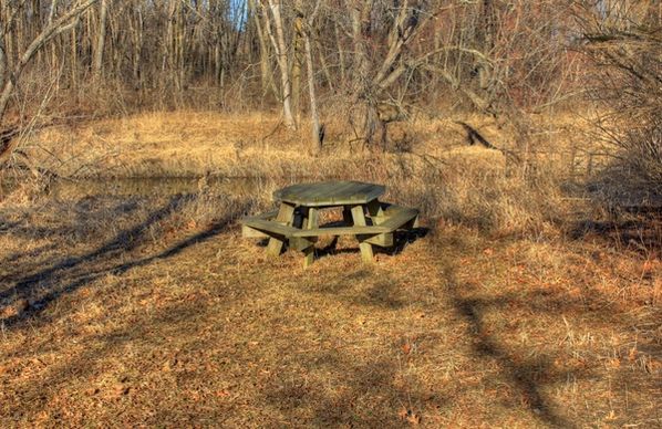 picnic table by the river on the 400 trail in wisconsin