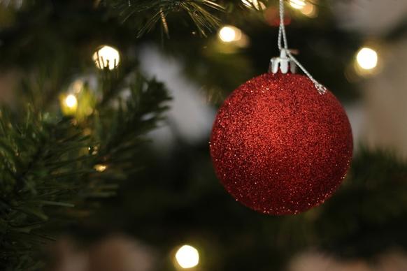 red ball ornament hanging on christmas tree