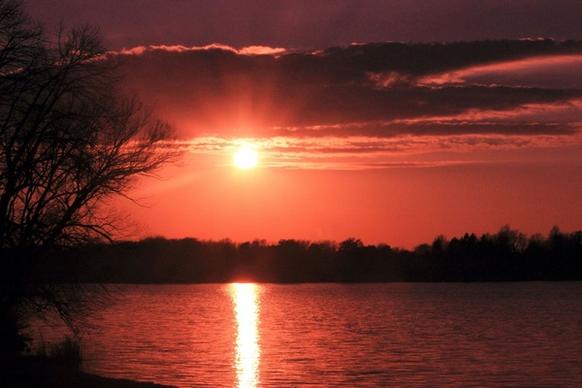 red sun over lake at pike lake state park wisconsin