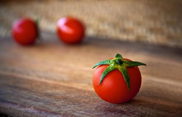 red tomato on a wood table